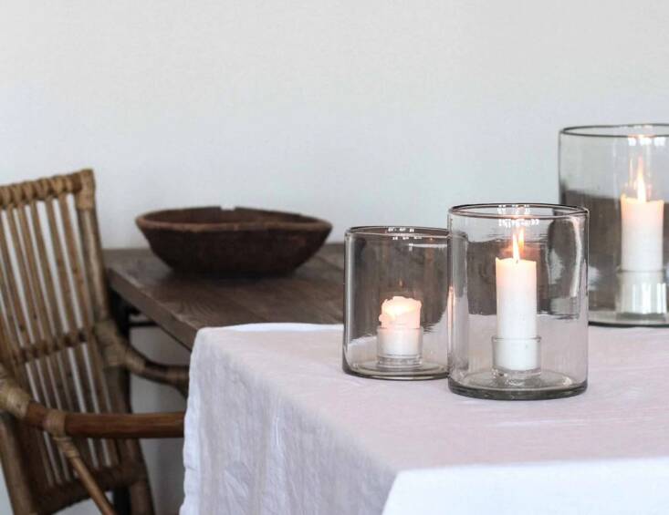 You can make do with one of those battery-operated candles, of course, but nothing beats the ambiance of a real candle flickering inside a handmade glass hurricane. Shop now.