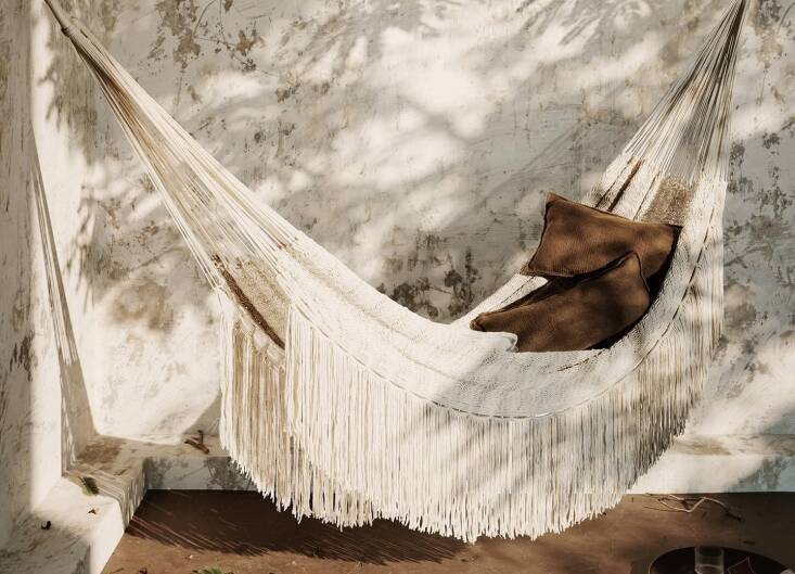 A soft spot for a solo nap (or a sweet destination for a daytime date), this hammock is hand-knotted from yarn spun from post-consumer plastic. Shop now.