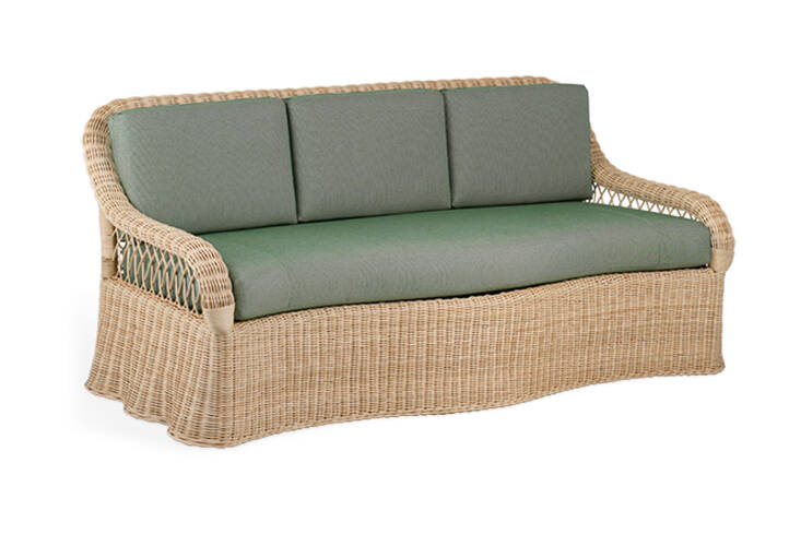 The Soane Rattan Lily Sofa is available in a range of standard rattan finishes with a loose seat and back cushion. Made in collaboration with Mark D Sikes, the sofa is inspired by draped linens and handmade by skilled weavers in Leicestershire.