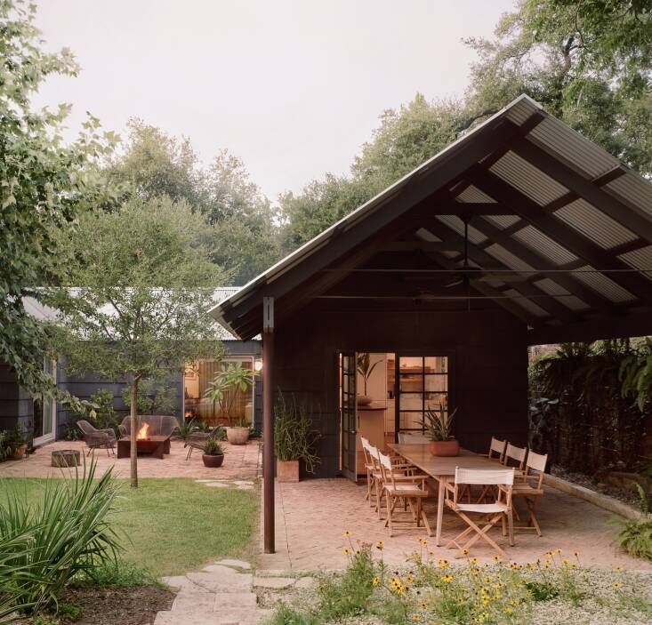 The house transformation took place in two stages, with the dining pavilion and garden renovation happening after the main house. When they extended the gable roof over the dining area, they added a brick patio laid out in a herringbone design. They also replaced the kitchen window with French doors.
