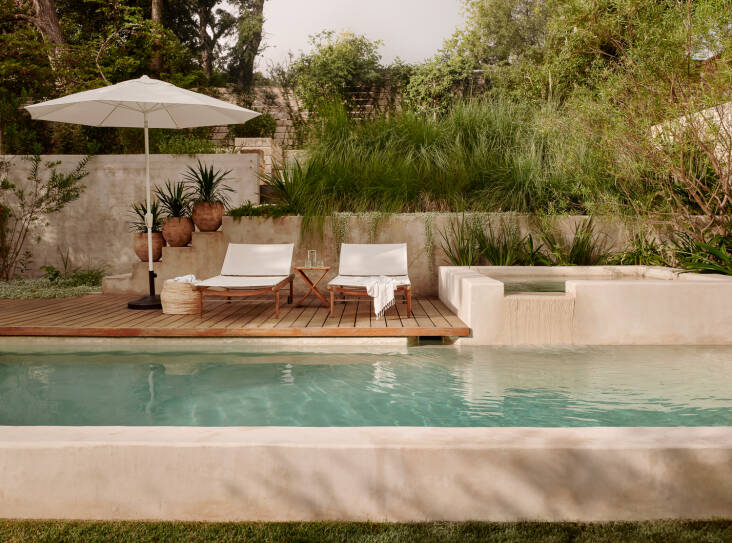 Cameron describes walking over the lawn and taking the steps up to the pool as a “ritual.” “When you turn around and sit in the loungers and reorient yourself back towards the home. It creates a strong dialogue of how to experience the entire property,” he says. The color of the chukum plaster was chosen to harmonize with the existing limestone elements on the property.