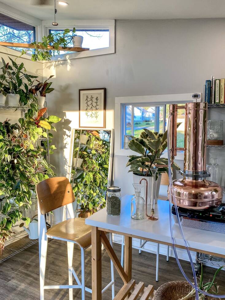 The shed is used as Ashlie’s office, a produce processing station, a meditation studio, and a home for their houseplants. She also makes her own essential oils with a copper distiller.