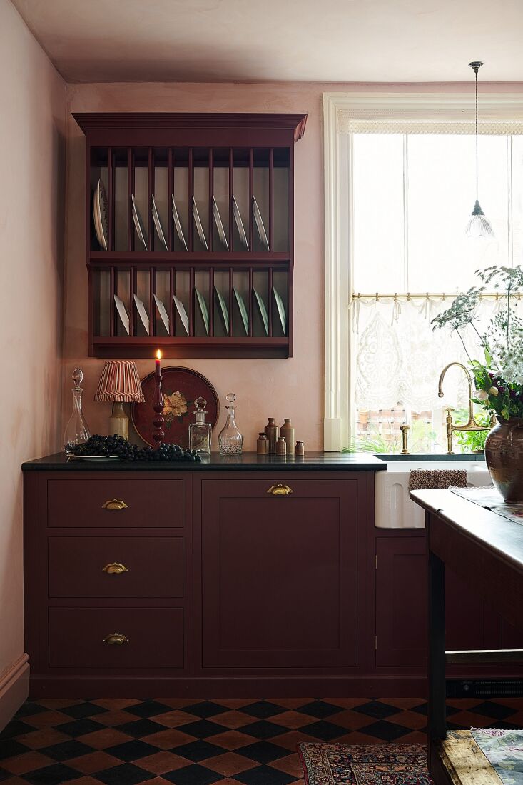 An autumnal vignette from Kitchen of the Week: Red, Pink, and Lace in a Former Victorian Lacemaker’s Grange. Photograph courtesy of deVOL.