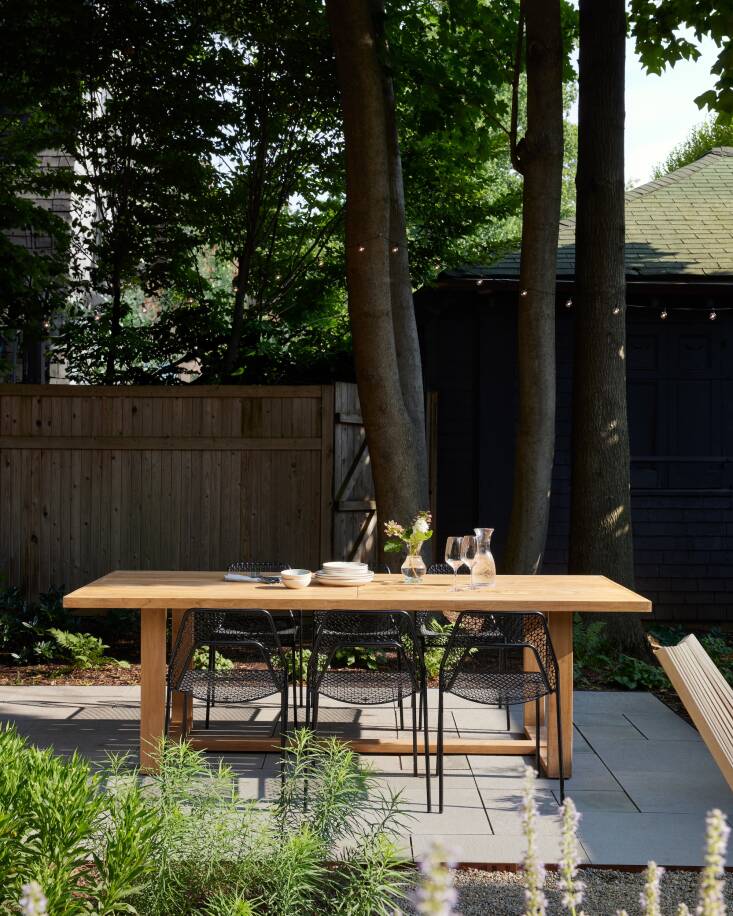 Osofsky and Bertulli brought on Built to Last Hardscapes to build the bluestone patio and specified a similarly hued gravel for the firepit area. Two tips from Osofsky: make sure the patio is large enough for guests to pull their chairs all the way out; and look for premium teak outdoor furniture, which will age gracefully and last longer than other woods. Williams-Sonoma Home no longer makes this particular dining table; here&#8\2\17;s a similar version. The Hot Mesh dining chairs are from Blu Dot.