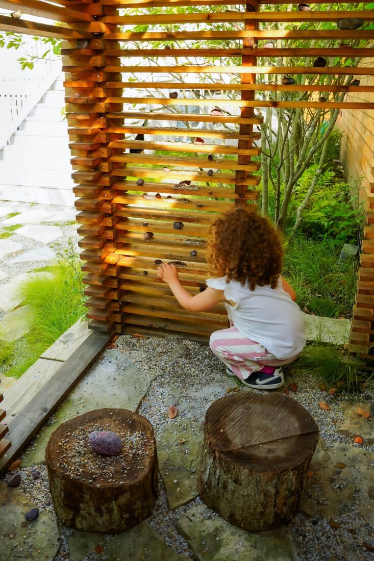 The 4-x-7 foot slatted playhouse echoes Lu — La Design’s Nest structures in New York City, which first brought the firm to our attention. Smith notes that the slats “invite children to collect ‘loose parts’ and engage in a rich play.” Made from the same wood as the fence, the structure recedes visually.