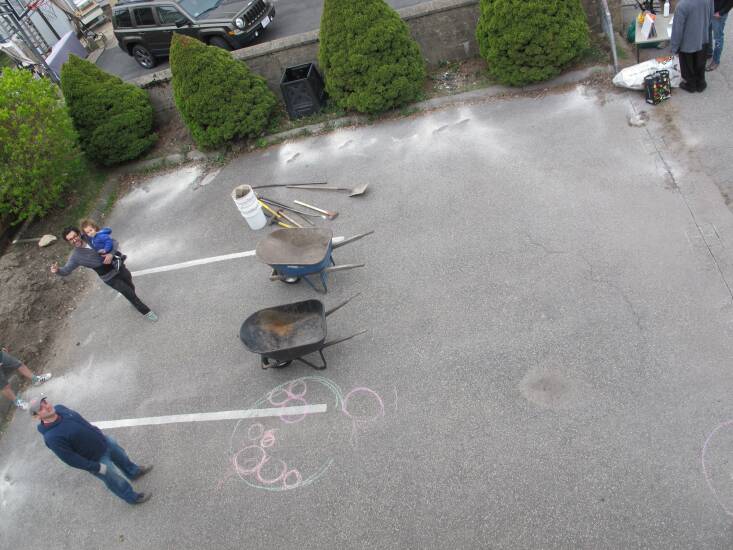 The yard behind Brunelle’s home was nothing but asphalt and a few conifers.