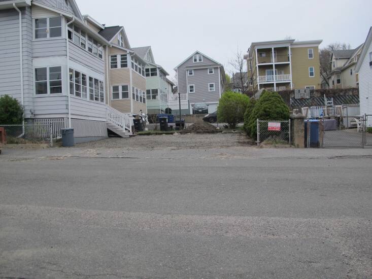 The gray-on-gray view of the parking lot from the street.