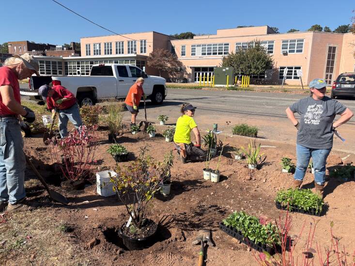 Volunteers planning and planting the garden. Native species that like wet feet were chosen for the project, including red twig dogwood, Virginia sweetspire, switchgrass, and showy goldenrod. Photograph courtesy of Kirk Barrett.