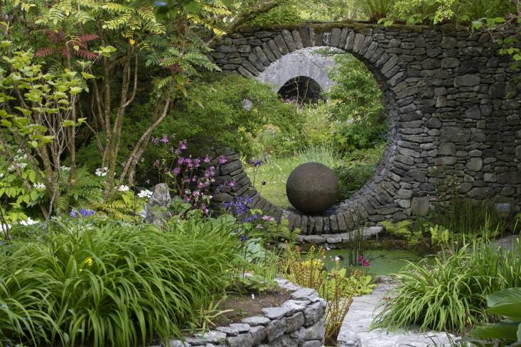 The enchanting garden of Irish garden designer Carl Wright could be straight from a children\2\17;s picture book. Built \17 years ago in County Clare on the West Coast of Ireland and crafted from limestone found in the garden, this moon gate blends harmoniously with the landscape and frames the nearby view of the bridge. Photograph by Carl Wright. (For more on this garden, see Required Reading: The Irish Garden.)