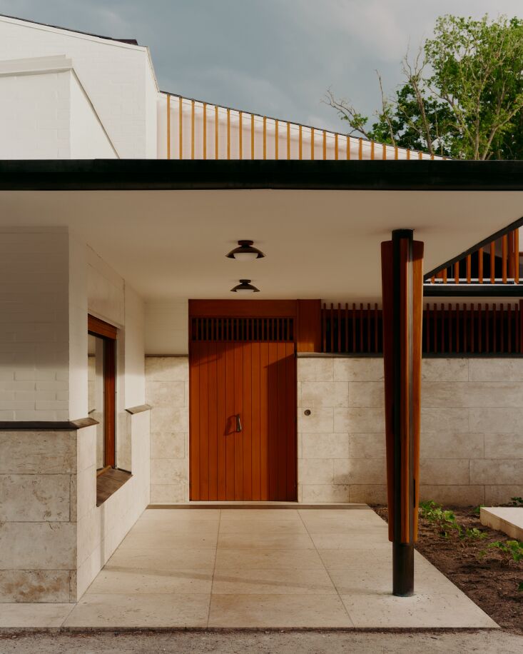 An Alvar Aalto building doesn\2\17;t need much embellishment, but this front door in a rust-orange hue certainly enhances its curb appeal. (Leading up to the door are two Arundel Mushroom Surface Mount lights by In Common With.) Photograph by Bastian Achard, from Maison Louis Carré: Aalto’s Architecture, Revisited by In Common With.