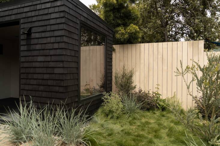 For a recent project, ORCA paired a newly-built black house with a natural wood fence. \2\20;We like the natural wood as a contrast to the black,” explains Sedlacek. “It creates layering and depth so the landscape doesn\2\17;t blend into the architecture.” Photograph by Cass Cleave for ORCA.