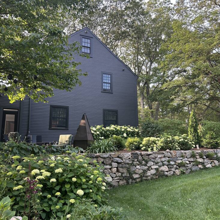 Food stylist and cookbook author Suzanne Lenzer, who moonlights as a woodworker and an avid gardener, painted her Connecticut home black, and it\2\17;s become a high-contrast canvas for the profusion of Annabelle hydrangeas planted around the house. Lenzer started with just black siding and then painted the trim black too for a uniform look. Photograph by Suzanne Lenzer.