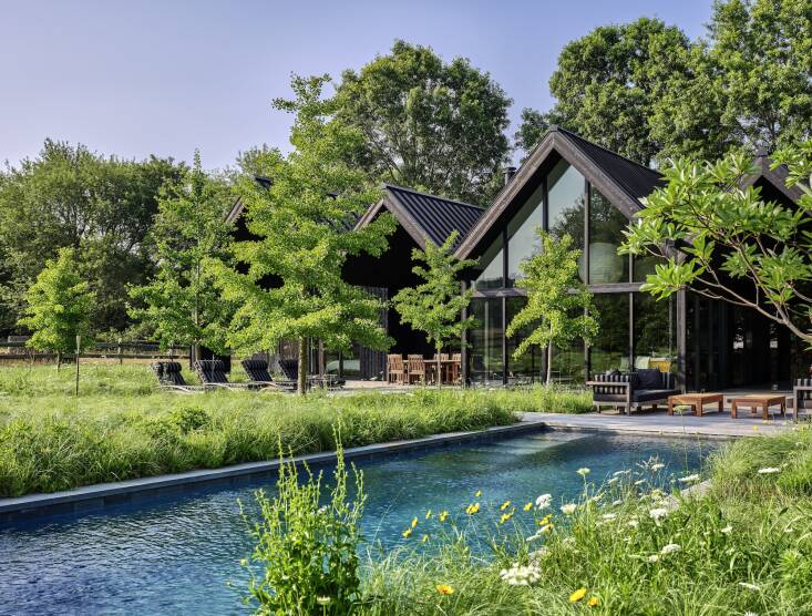 When Workshop/APD’s clients asked them to build them a black beach house, the firm delivered one clad in Nakamoto Forestry’s black Pika-Pika yakisugi siding. \2\20;This rich, dark exterior palette allows the home to recede into the tree line and its shadows in a way that a more traditional white Hamptons home would not,” says Tyler Marshall, associate principal at Workshop/APD. The landscape design is by Abby Lawless of FARM Landscape Design. Photograph by Read McKendree for Workshop/APD