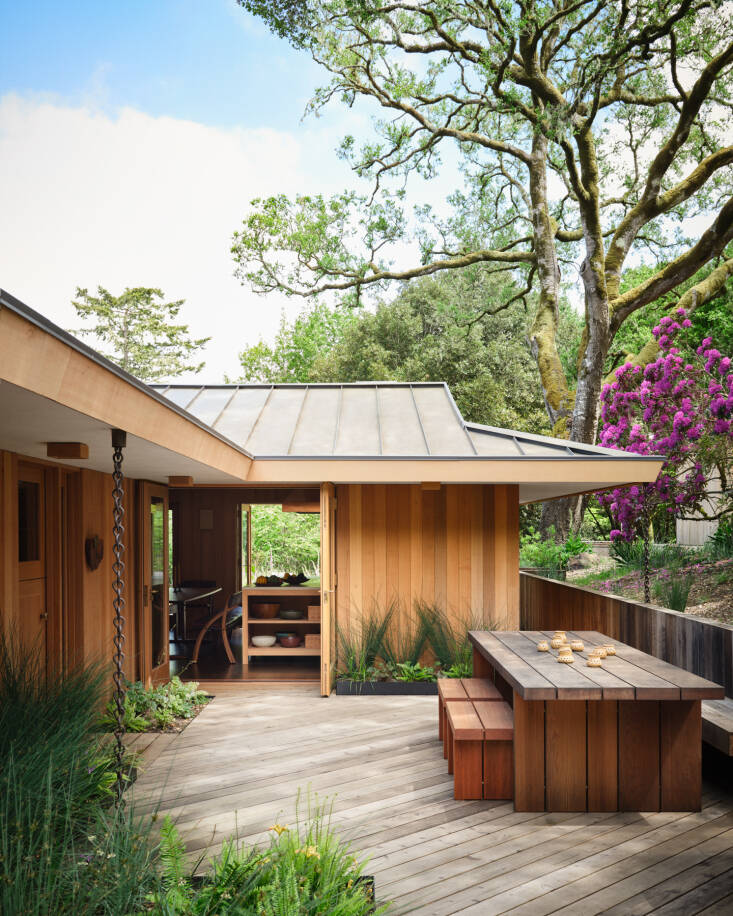The cedar boardwalk and decking where designed with horizontally-laid walking paths and diagonally-placed areas for gathering. The redwood table and bench are by Nobuto Suga commissioned by Commune Design. Photo by Stephen Kent Johnson.