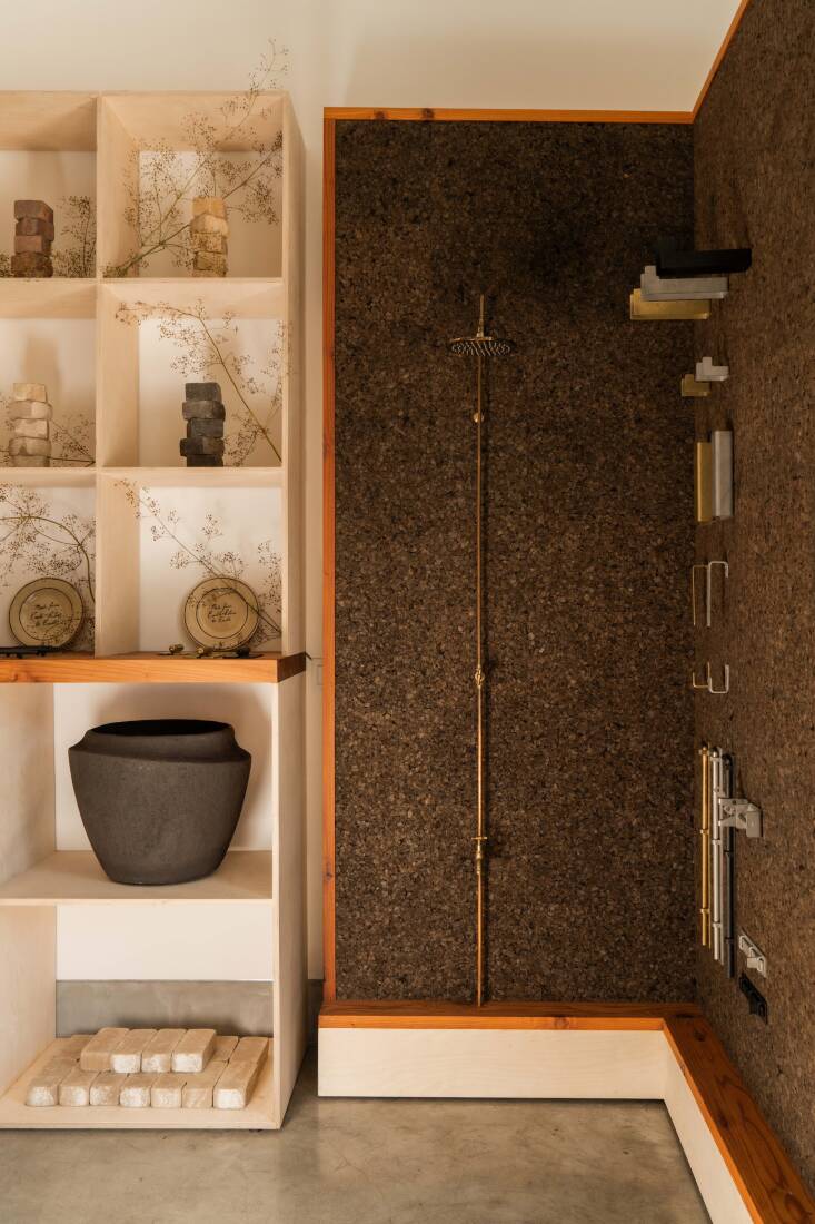 A cork display wall shows off some of ORCA’s hardware, outdoor shower fittings, and exterior lighting.